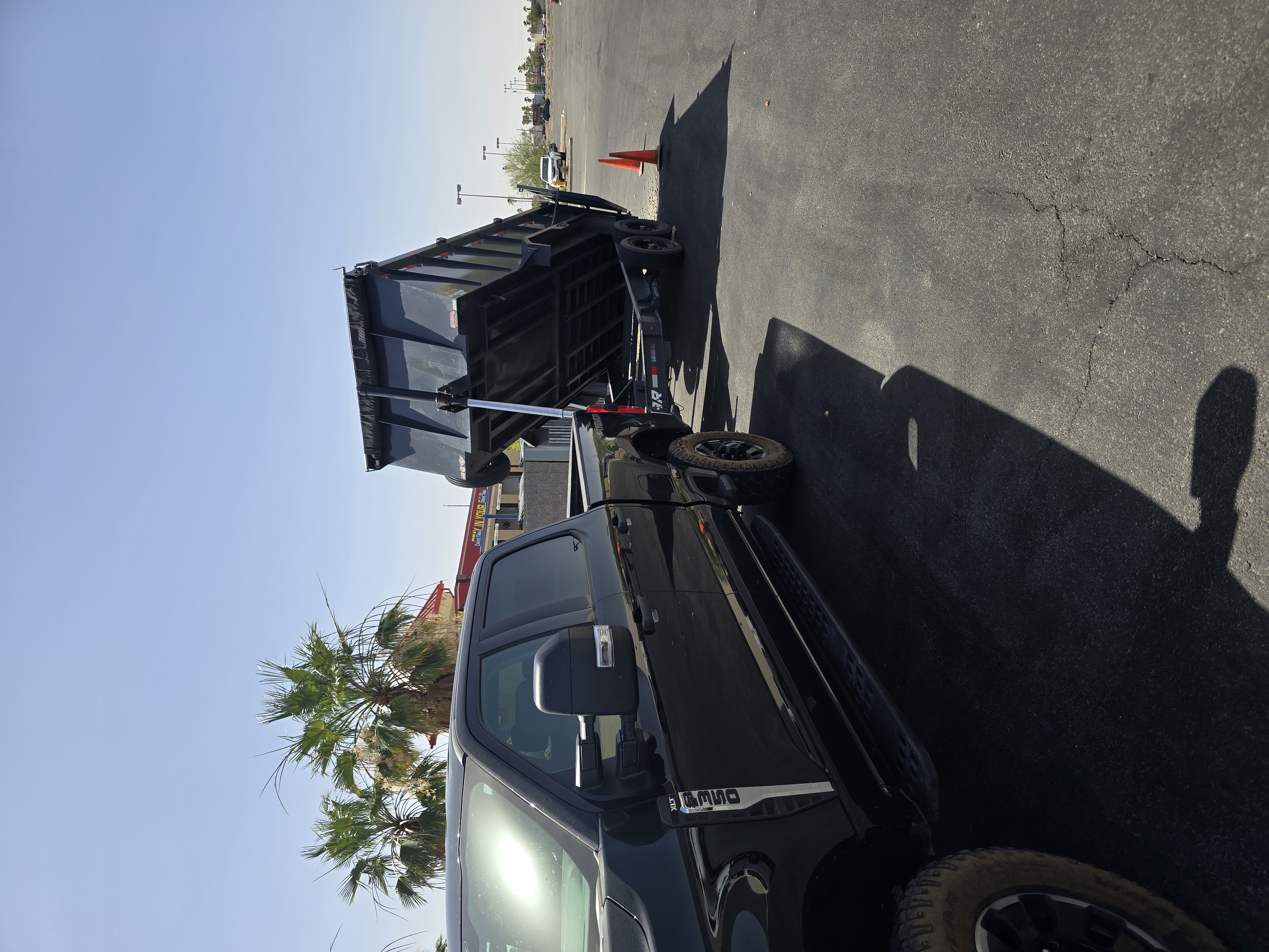 F350 and dump trailer used for hauling cleared material